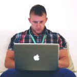 Man blogging on laptop